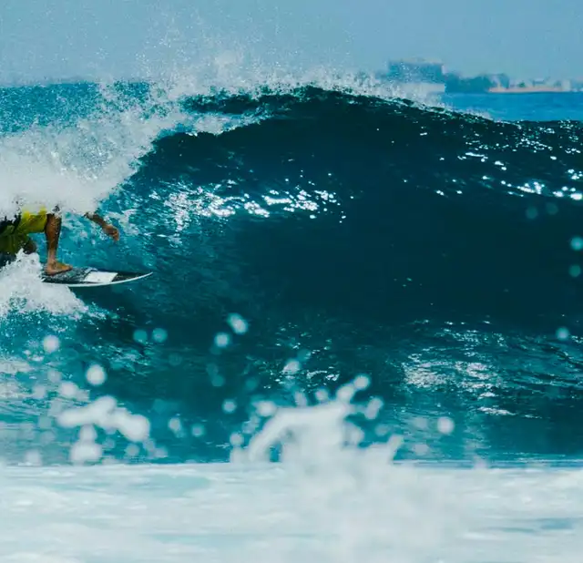 Surfer riding a wave near Thulusdhoo